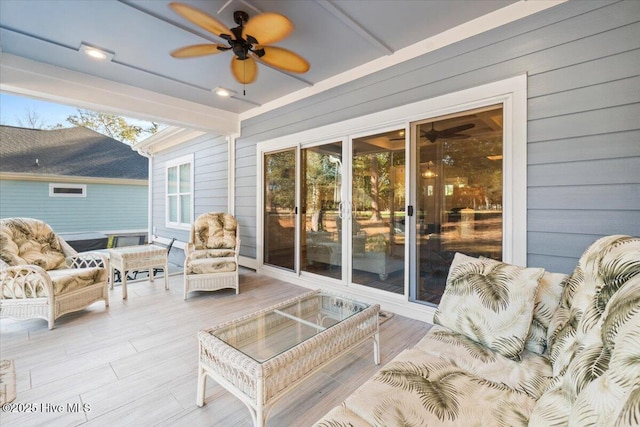 sunroom featuring ceiling fan