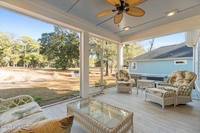 sunroom / solarium with a ceiling fan