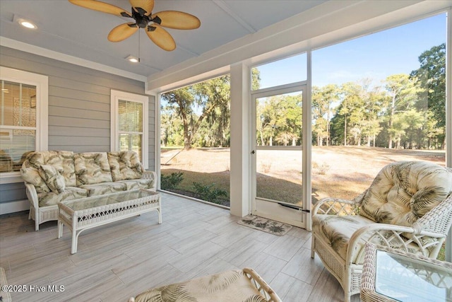 sunroom featuring ceiling fan