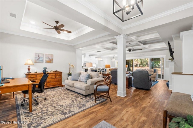 office space with visible vents, ceiling fan with notable chandelier, beamed ceiling, and wood finished floors