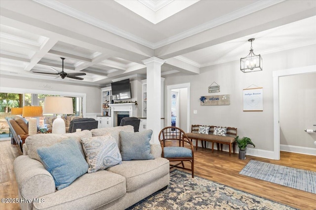 living area with wood finished floors, baseboards, coffered ceiling, beam ceiling, and a fireplace