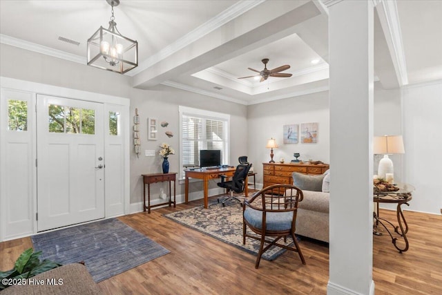 entryway featuring visible vents, crown molding, a tray ceiling, and wood finished floors