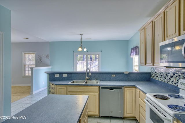 kitchen featuring appliances with stainless steel finishes, sink, light tile patterned floors, and light brown cabinetry