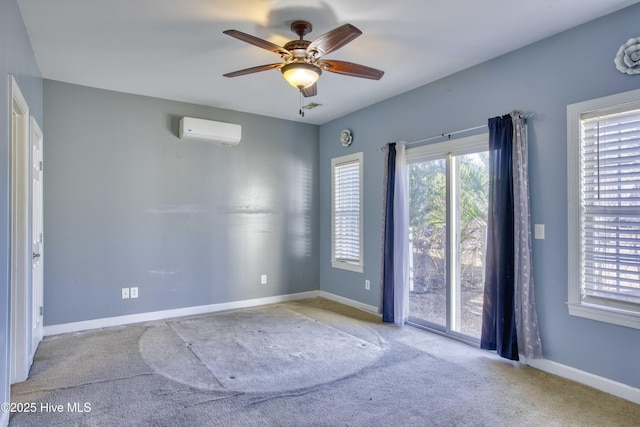 carpeted spare room featuring a wall mounted AC and ceiling fan