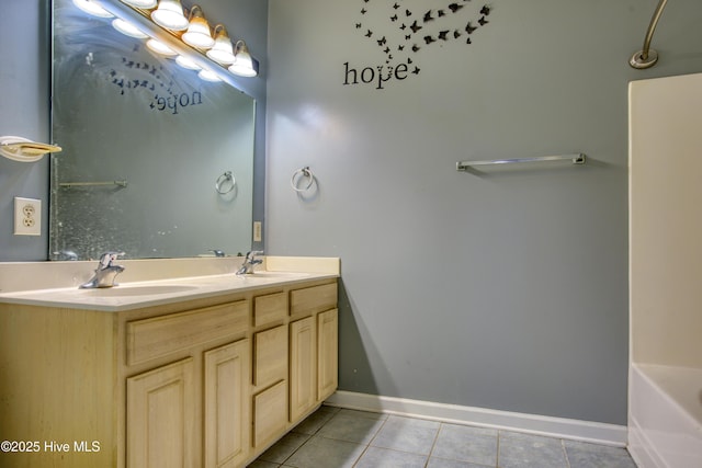 bathroom with vanity, tile patterned floors, and a bathing tub