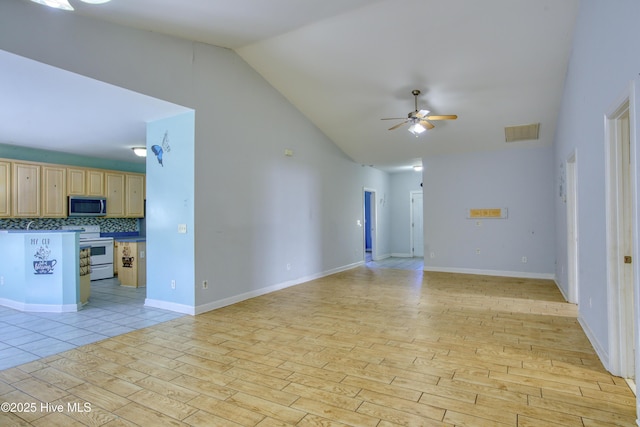 unfurnished living room with ceiling fan, lofted ceiling, and light wood-type flooring