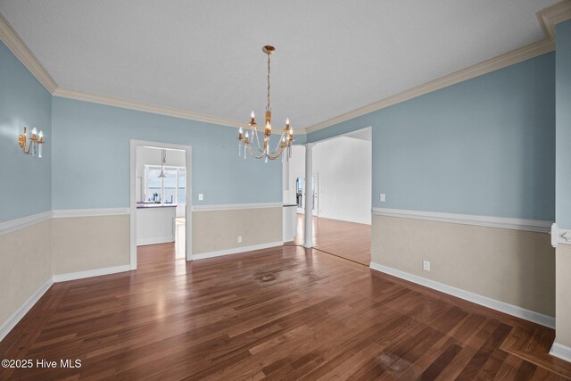 530 E St, Belhaven, NC 27810 - unfurnished dining area with crown molding, baseboards, an inviting chandelier, and wood finished floors