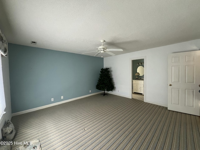 spare room with ceiling fan and a textured ceiling