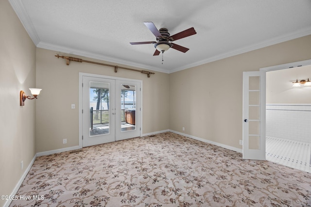 carpeted spare room with crown molding, ceiling fan, baseboards, and french doors