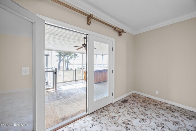 doorway with baseboards, ornamental molding, light carpet, and ceiling fan