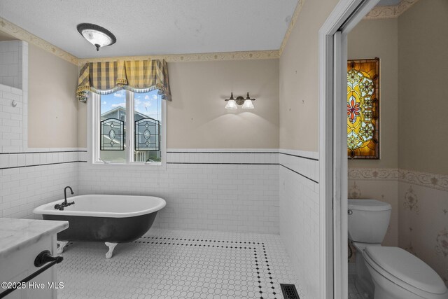 530 E St, Belhaven, NC 27810 - bathroom with toilet, tile walls, and wainscoting