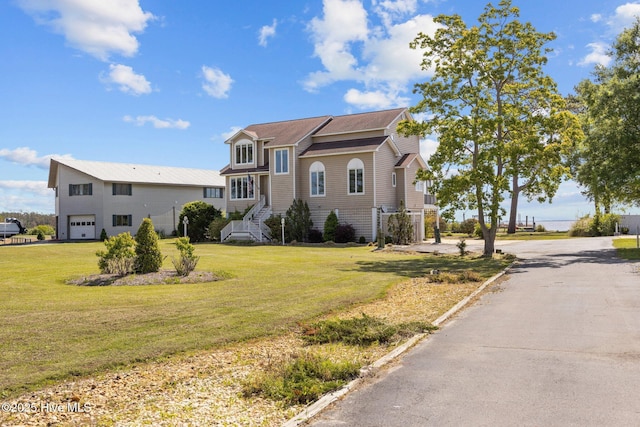 view of front of property with an attached garage, driveway, and a front yard