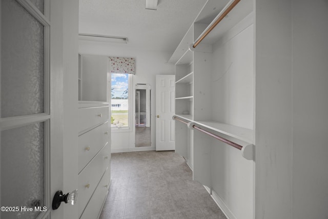 spacious closet featuring light tile patterned floors