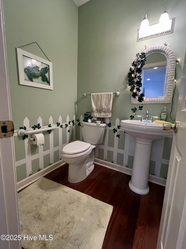 bathroom with sink, hardwood / wood-style flooring, and toilet