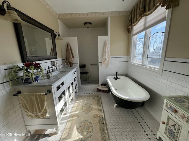 bathroom with vanity, tile walls, tile patterned flooring, and plus walk in shower