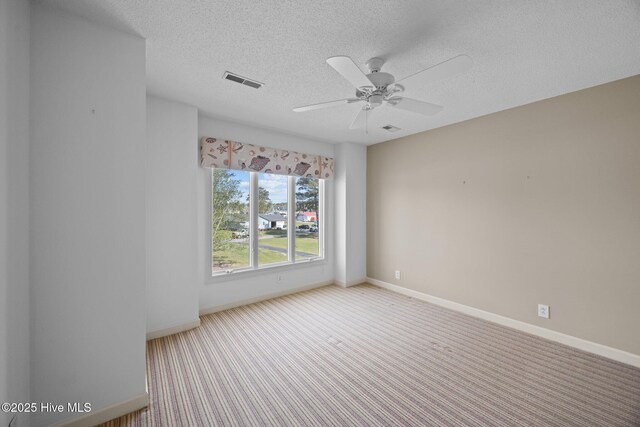 530 E St, Belhaven, NC 27810 - spare room with visible vents, baseboards, ceiling fan, a textured ceiling, and carpet flooring