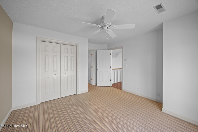 unfurnished bedroom with visible vents, baseboards, and carpet floors