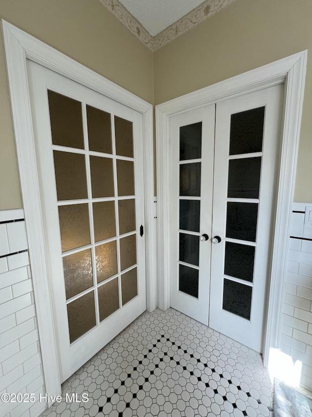 doorway to outside with french doors and tile patterned floors