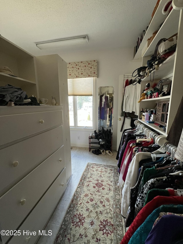 spacious closet featuring light tile patterned flooring