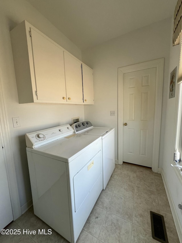 laundry room with cabinets and washing machine and dryer