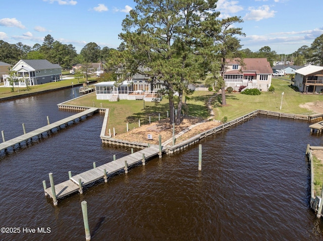 dock area featuring a residential view, a water view, and a lawn