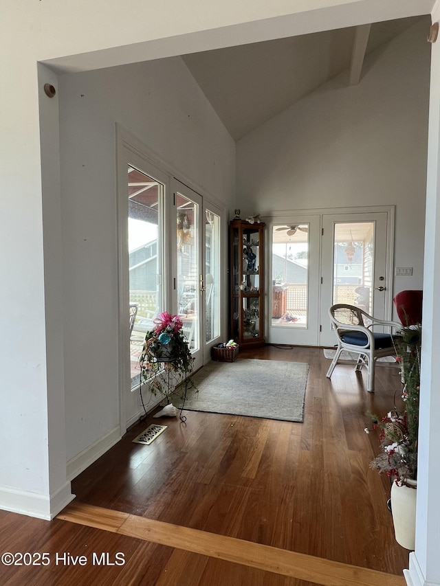 entryway featuring hardwood / wood-style flooring and vaulted ceiling with beams