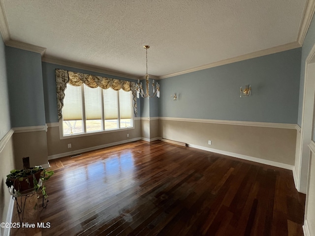 unfurnished dining area featuring wood-type flooring, ornamental molding, a textured ceiling, and a notable chandelier