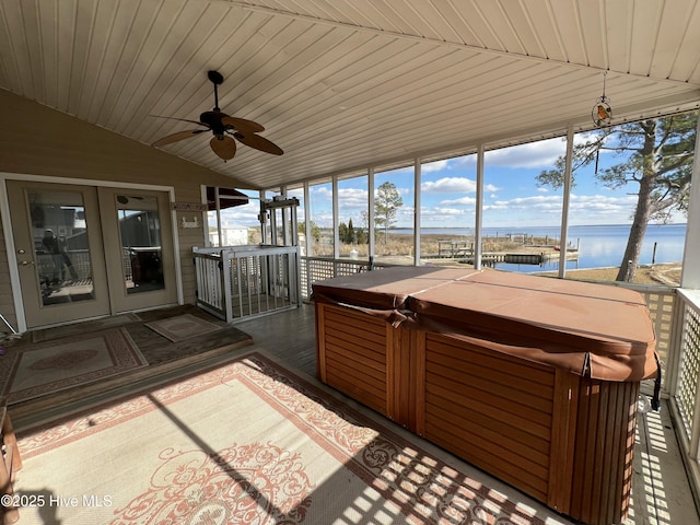 unfurnished sunroom with wooden ceiling, a jacuzzi, a water view, and vaulted ceiling