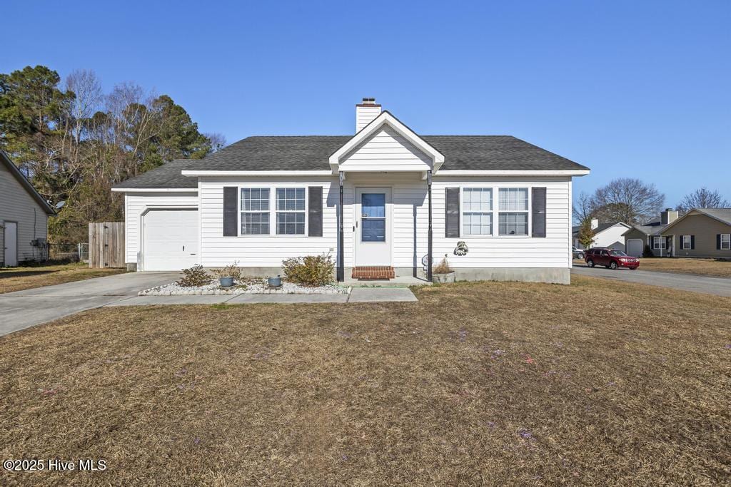 view of front of house with a garage and a front yard