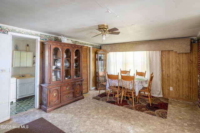 dining area with ceiling fan and sink