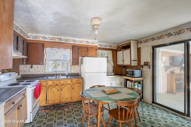 kitchen featuring white appliances and sink