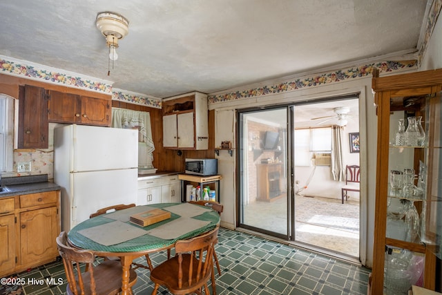 kitchen with ceiling fan, white fridge, and a textured ceiling