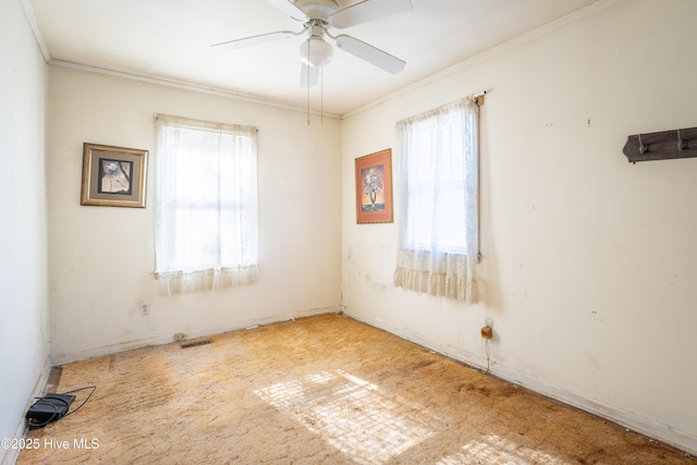 unfurnished room featuring ceiling fan and ornamental molding