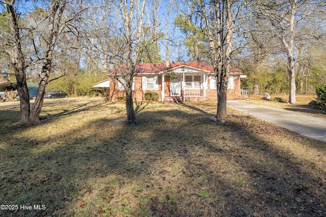 view of front of home featuring covered porch and a front yard