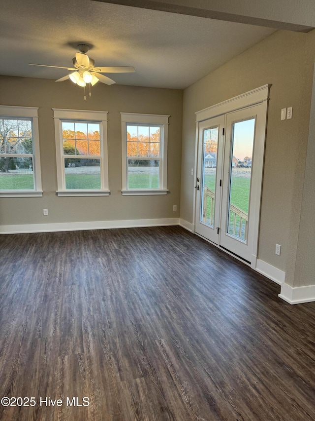 spare room with ceiling fan and dark hardwood / wood-style flooring