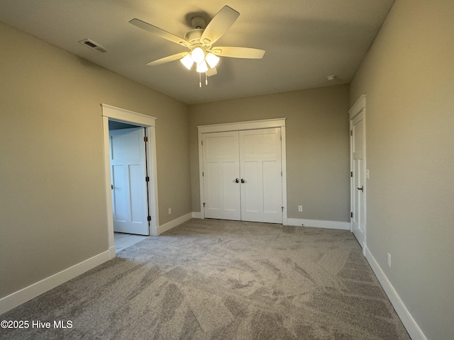 unfurnished bedroom with ceiling fan, light colored carpet, and a closet