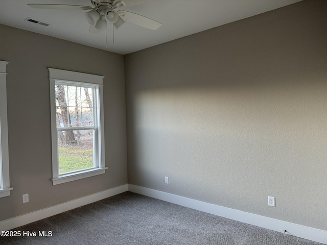 empty room featuring ceiling fan and carpet flooring