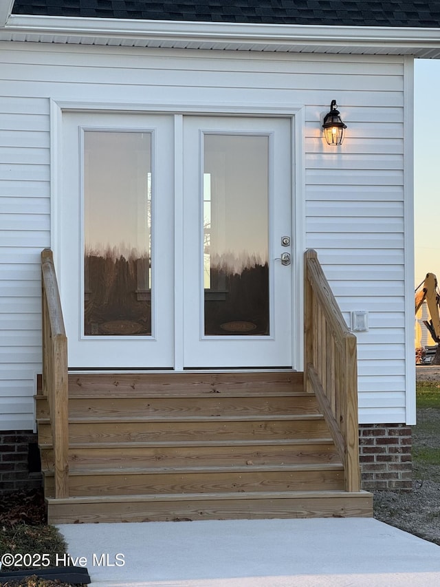 view of exterior entry at dusk