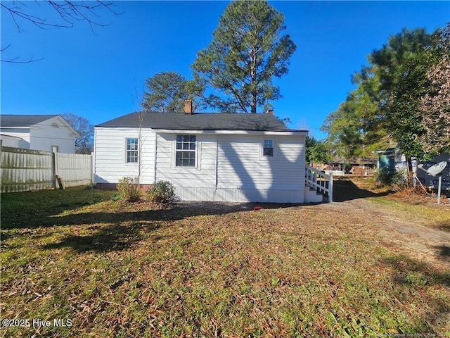 rear view of house with a yard