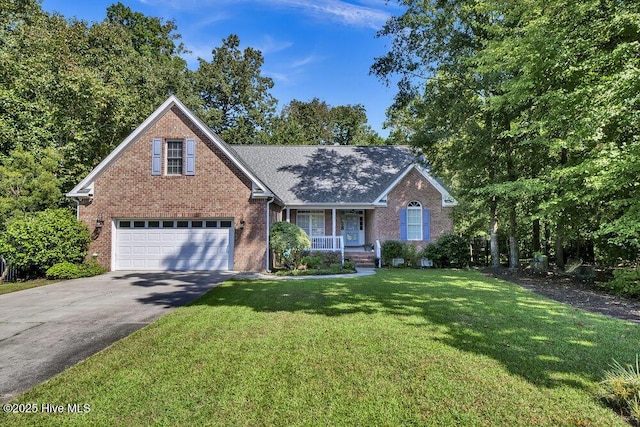 front of property with covered porch, a garage, and a front lawn