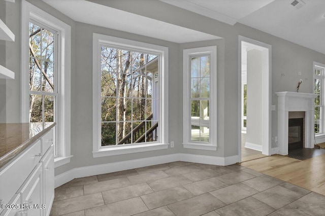 unfurnished dining area featuring light tile patterned floors