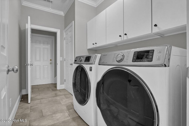 laundry room featuring washer and dryer, cabinets, and crown molding