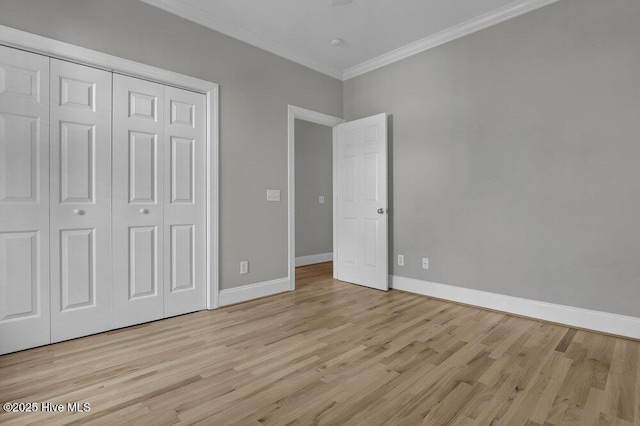 unfurnished bedroom featuring light hardwood / wood-style flooring, a closet, and ornamental molding