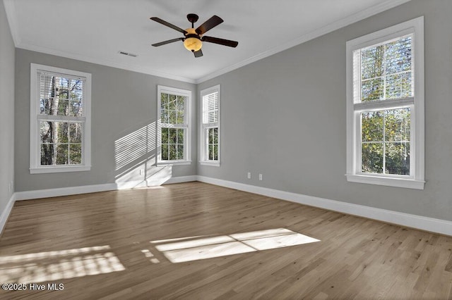 spare room featuring ceiling fan, light wood-type flooring, and crown molding