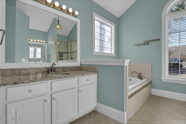 bathroom featuring tile patterned flooring, vanity, independent shower and bath, and vaulted ceiling