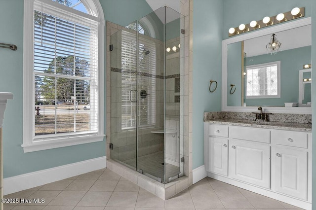 bathroom with tile patterned flooring, vanity, and an enclosed shower