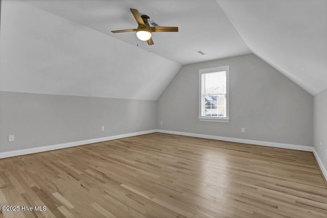 additional living space featuring ceiling fan, vaulted ceiling, and light hardwood / wood-style flooring