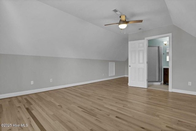 bonus room with light wood-type flooring, vaulted ceiling, and ceiling fan