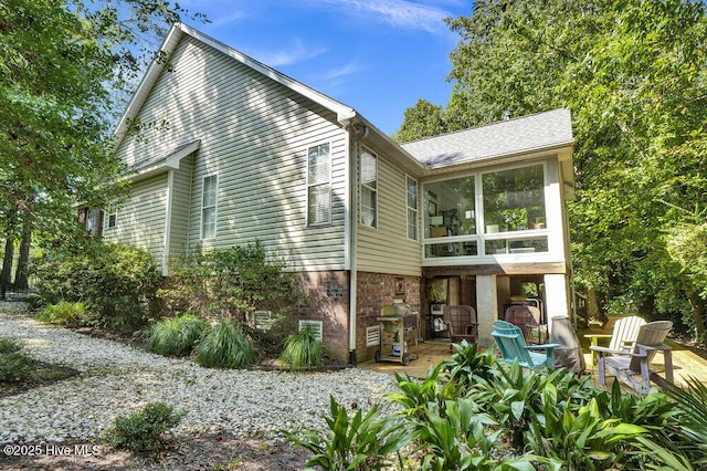 back of property featuring a sunroom