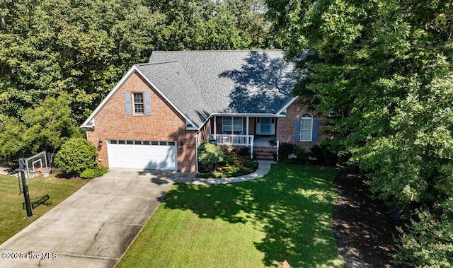 view of front of house featuring a garage, covered porch, and a front yard